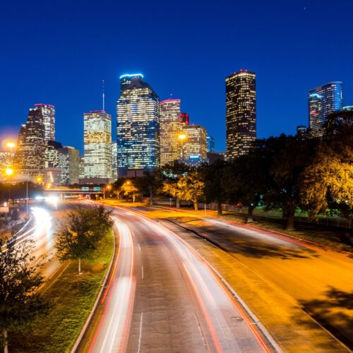 Houston night scene with highway and lights with skyline in the background