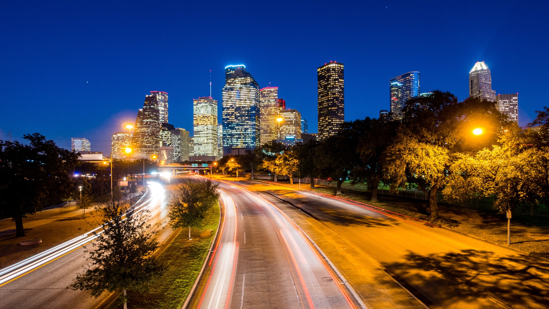 Houston night scene with highway and lights with skyline in the background