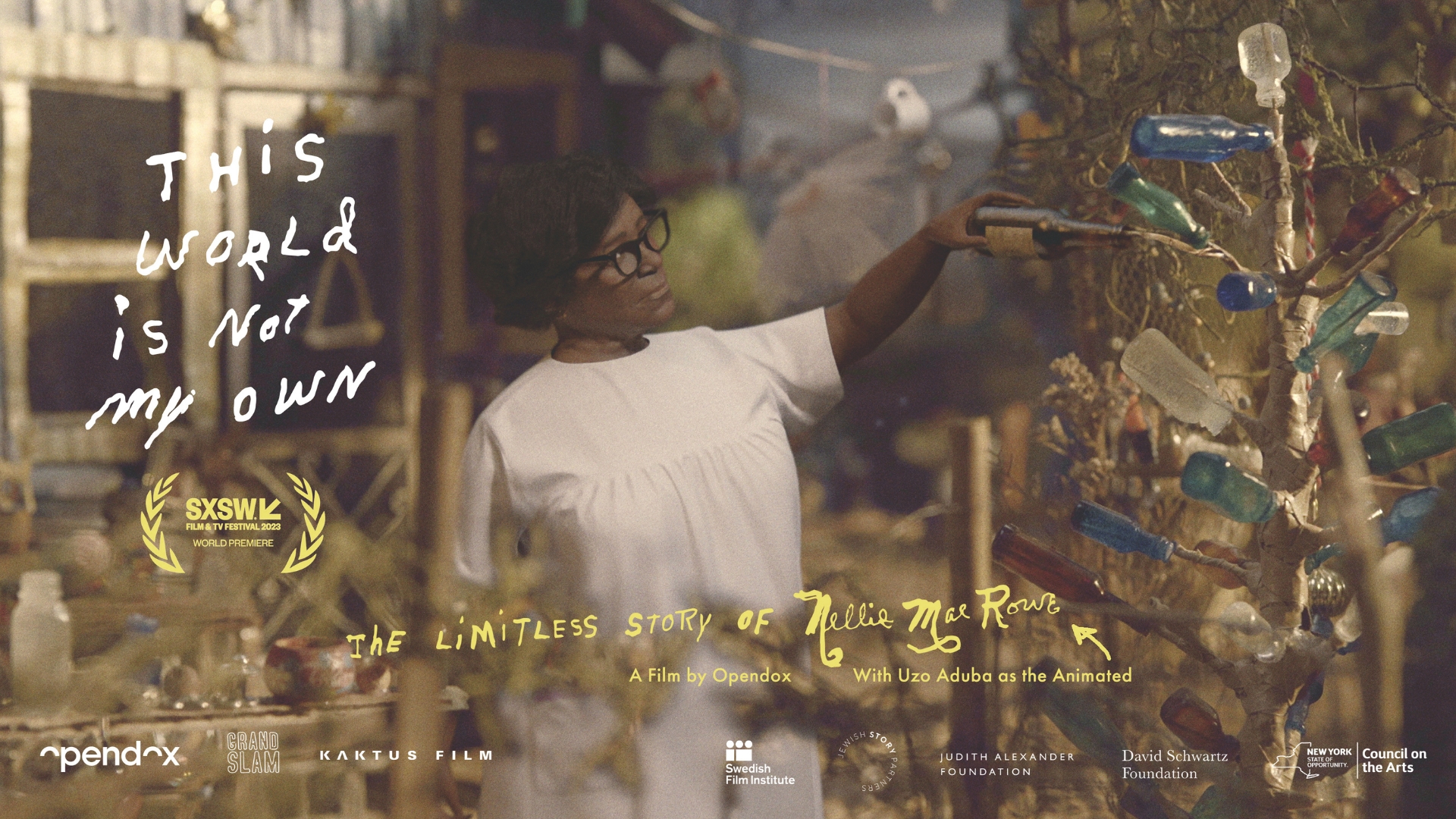 A promotional poster for the film "This World Is Not My Own" shows a woman in a white dress and black glasses carefully adjusting a tree made of glass bottles. The poster text is handwritten and reads "This World Is Not My Own: The Limitless Story of Nellie Mae Rowe." Film festival laurels and production logos are visible, with soft lighting creating an artistic and serene mood.